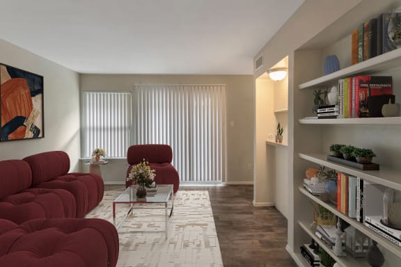 This is a photo of a virtually staged living room in the 650 square foot 1 bedroom, 1 bath apartment at Preston Park Apartments in Dallas, TX.