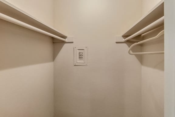 This is a photo of the bedroom walk-in closet in the 650 square foot 1 bedroom, 1 bath apartment at Preston Park Apartments in Dallas, TX