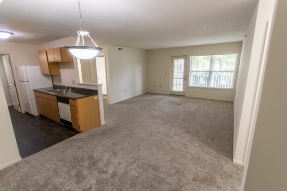 This is photo of the kitchen and living room from the dining in the 1056 square foot, 2 bedroom Gainsway floor plan at Trails of Saddlebrook Apartments in Florence, KY.