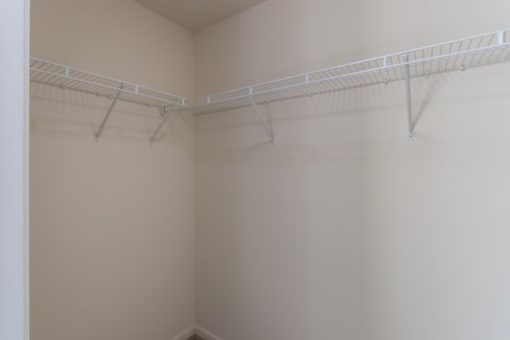 This is a photo of the primary bedroom walk-in closet in the 1226 square foot 3 bedroom, 2 bath Hambletonian at Trails of Saddlebrook Apartments in Florence, KY.
