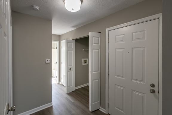 This is photo of the utility closet with washer and dryer connections in the hallway of the 852 square foot, 1 bedroom, 1 bath Fairlawn floor plan at Trails of Saddlebrook Apartments in Florence, KY.