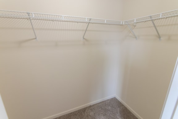 This is a photo of the master bedroom walk-in closet in the 1226 square foot 3 bedroom Hambletonian at Trails of Saddlebrook Apartments in Florence, KY.