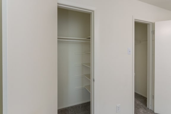 This is a photo of the closets in the primary bedroom in the 963 square foot 2 bedroom, 2 bath apartment at The Summit at Midtown Apartments in Dallas, TX.