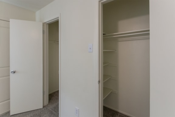 This is a photo of the closets in the primary bedroom in the 963 square foot 2 bedroom, 2 bath apartment at The Summit at Midtown Apartments in Dallas, TX.