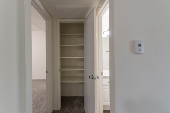 This is a photo of the hall closet in the 963 square foot 2 bedroom, 2 bath apartment at The Summit at Midtown Apartments in Dallas, TX.