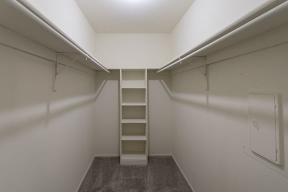 This is a photo of the second bedroom walk-in closet in the 963 square foot 2 bedroom, 2 bath apartment at The Summit at Midtown Apartments in Dallas, TX.