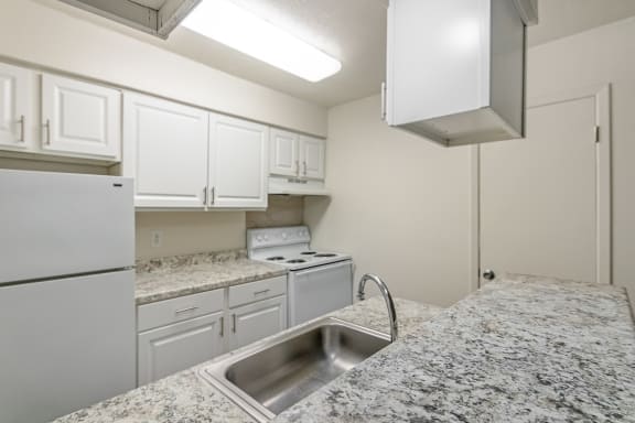 This is a photo of the kitchen in the 486 square foot 1 bedroom apartment at The Summit at Midtown Apartments in Dallas, TX.
