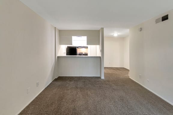 This is a photo of the living room and dining area in the 558 square foot 1 bedroom apartment at The Summit at Midtown Apartments in Dallas, TX.g into the kitchen and dining area.