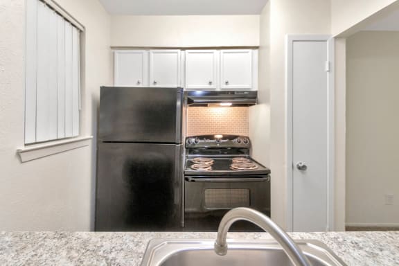 This is a photo of the kitchen with pantry in the 558 square foot 1 bedroom apartment at The Summit at Midtown Apartments in Dallas, TX.