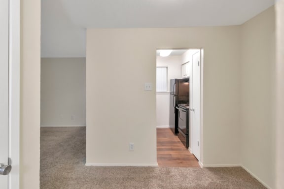 This is a photo of the kitchen from the dining area in the 558 square foot 1 bedroom apartment at The Summit at Midtown Apartments in Dallas, TX.