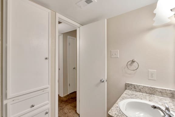 This is a photo of the bathroom with built in shelves in the 558 square foot 1 bedroom apartment at The Summit at Midtown Apartments in Dallas, TX.