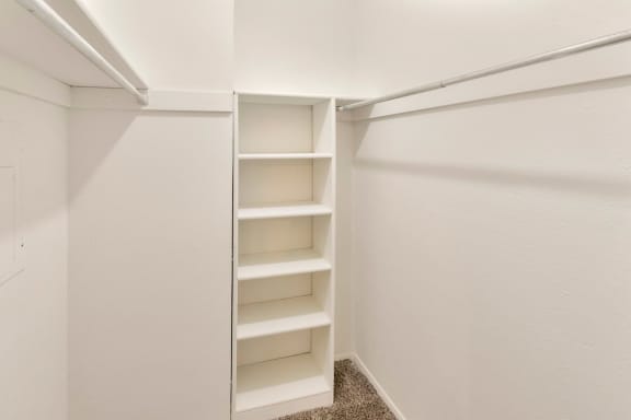 This is a photo of the walk-in closet in the 558 square foot 1 bedroom apartment at The Summit at Midtown Apartments in Dallas, TX.