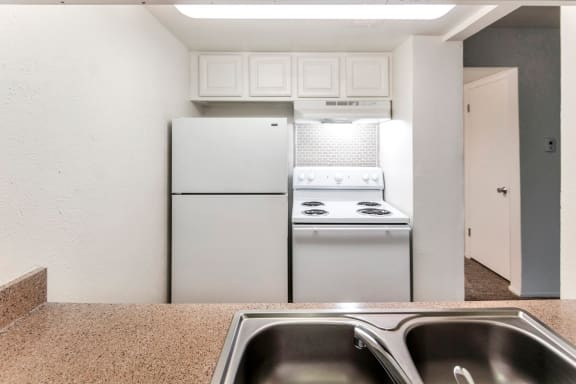 This is a photo of the kitchen in the 576 square foot 1 bedroom apartment at The Summit at Midtown Apartments in Dallas, TX.