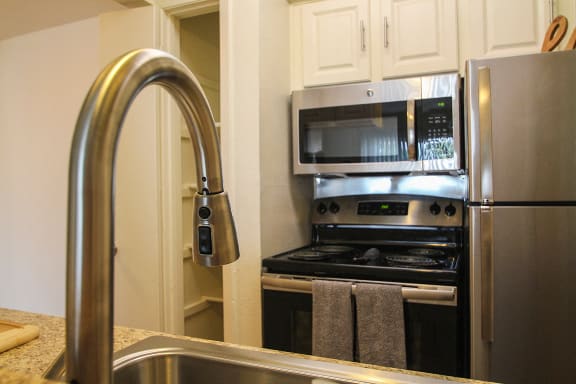 This is a photo of stainless steel appliances in the kitchen of a 558 square foot 1 bedroom apartment at The Summit at Midtown Apartments in Dallas, TX.