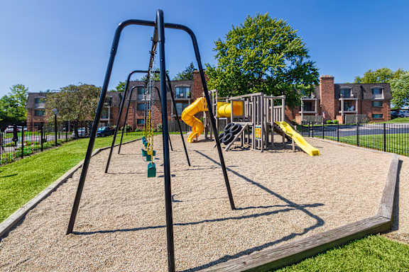 Swing set and playground area with safety surface at Village East Apartments in Franklin, Ohio