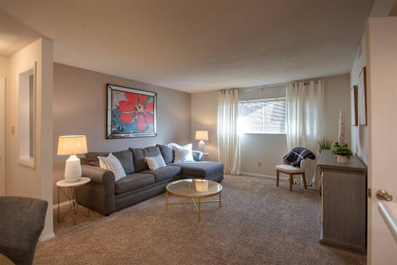 This is a photo of the living room in the 822 square foot, 2 bedroom, 1 bath floor plan at Village East Apartments in Franklin, OH.