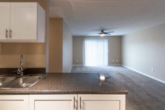 This is a photo of the living room from the kitchen in the 1170 square foot 2 bedroom, 2 bath Freedom Balcony at Washington Place Apartments in Miamisburg, Ohio in Washington Township.
