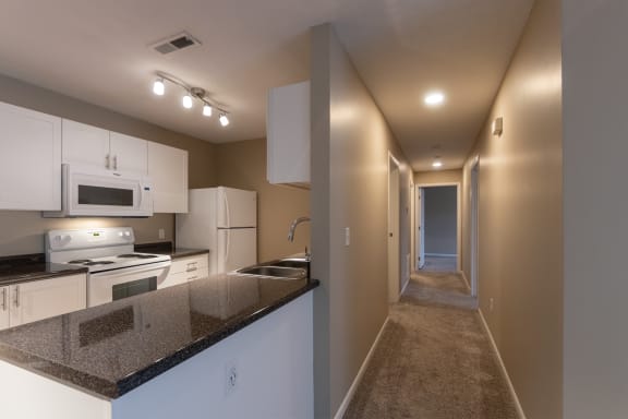 This is a photo of the kitchen and hallway in the 1170 square foot 2 bedroom, 2 bath Freedom Balcony at Washington Place Apartments in Miamisburg, Ohio in Washington Township.