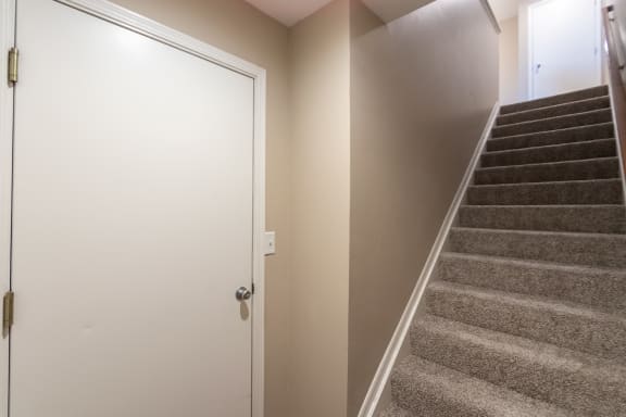 This is a photo of the entryway and stairs to to the second floor in the 1040 square foot 2 bedroom, 1 bath Patriot at Washington Place Apartments in Miamisburg, Ohio in Washington Township.