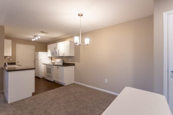 This is a photo of the kitchen and dining area in the 1040 square foot 2 bedroom, 1 bath Patriot at Washington Place Apartments in Miamisburg, Ohio in Washington Township.