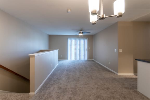 This is a photo of the living room from the dining area in the 1040 square foot 2 bedroom, 1 bath Patriot at Washington Place Apartments in Miamisburg, Ohio in Washington Township.