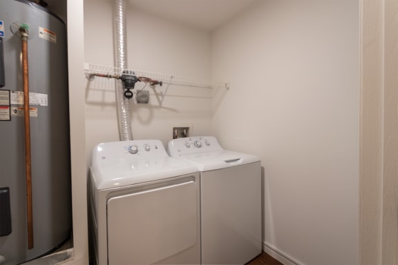 This is a photo of the full-size washer and dryer in the utility room of the 1040 square foot 2 bedroom, 1 bath Patriot at Washington Place Apartments in Miamisburg, Ohio in Washington Township.