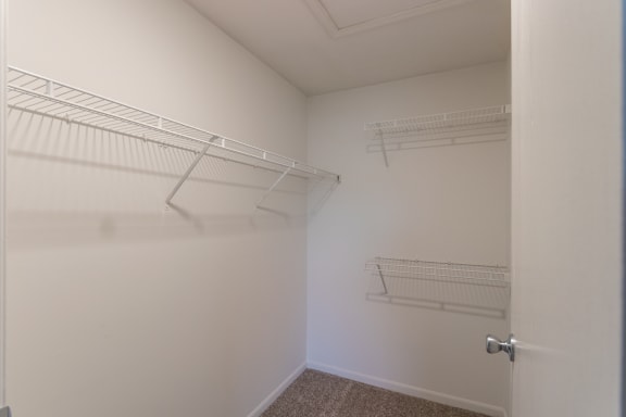 This is a photo of the primary bedroom walk-in closet in the 1040 square foot 2 bedroom, 1 bath Patriot at Washington Place Apartments in Miamisburg, Ohio in Washington Township.