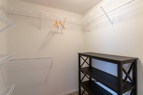 This is a photo of the second bedroom walk-in closet of the 890 square foot 2 bedroom, 2 bath Liberty at Washington Place Apartments in in Miamisburg, Ohio in Washington Township.