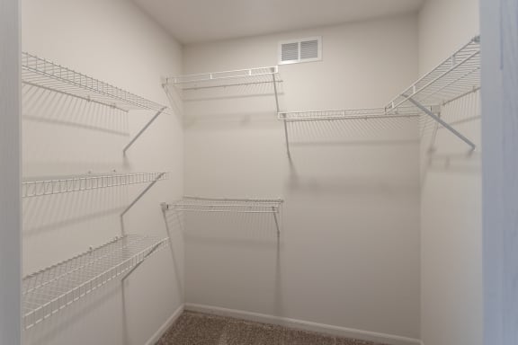 This is a photo of the second bedroom walk-in closet in the 890 square foot 2 bedroom, 1 bath Liberty (lower) at Washington Place Apartments in Miamisburg, Ohio in Washington Township.