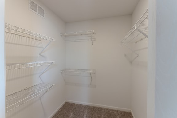 This is a photo of the primary bedroom walk-in closet in the 890 square foot 2 bedroom, 1 bath Liberty (lower) at Washington Place Apartments in Miamisburg, Ohio in Washington Township.