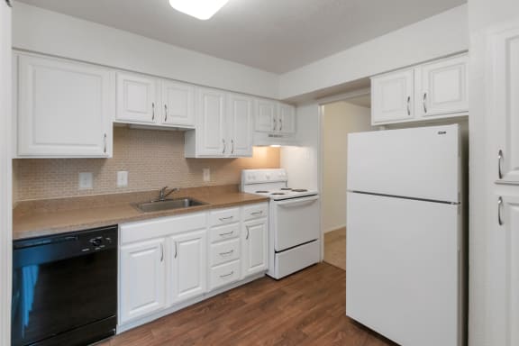 This is a photo of the kitchen of the 751 square foot 1 bedroom apartment at Woodbridge Apartments in Dallas, TX.