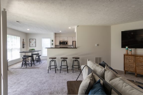 This is a photo of the kitchen and dining room from the living room  of the 1100 square foot 2 bedroom Kettering floor plan at Washington Park Apartments in Centerville, OH.