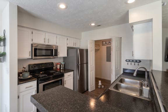 This is a photo of the kitchen of the 1100 square foot 2 bedroom Kettering floor plan at Washington Park Apartments in Centerville, OH.