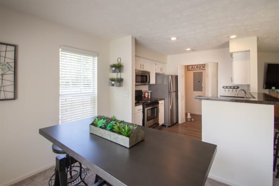 This is a photo of the kitchen from the diding room of the 1100 square foot 2 bedroom Kettering floor plan at Washington Park Apartments in Centerville, OH.