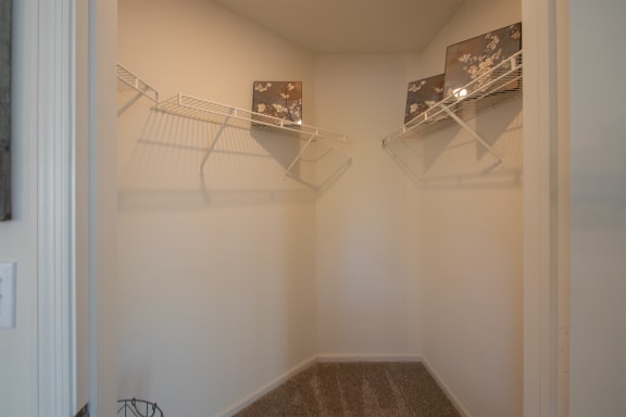 This is a photo of the primary bedroom walk-in closet of the 1100 square foot 2 bedroom Kettering floor plan at Washington Park Apartments in Centerville, OH.