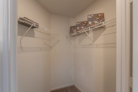 This is a photo of the primary bedroom walk-in closet in the 1100 square foot 2 bedroom Kettering floor plan at Washington Park Apartments in Centerville, OH.