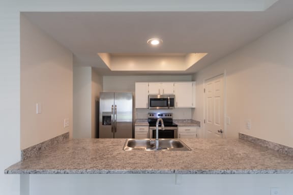 This is a photo of the kitchen of the 1500 square foot 3 bedroom, 2 and a half bath with 2-car garage Bellbrook floor plan at Washington Park Apartments in Centerville, OH.