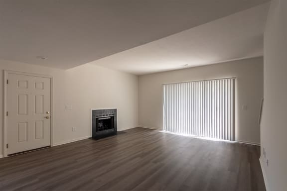 This is a photo of the living room with fireplace of the 1500 square foot 3 bedroom, 2 and a half bath with 2-car garage Bellbrook floor plan at Washington Park Apartments in Centerville, OH.
