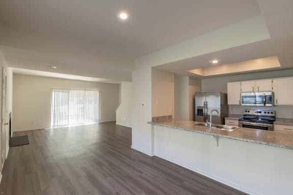 This is a photo of the kitchen and dining room of the 1500 square foot 3 bedroom, 2 and a half bath with 2-car garage Bellbrook floor plan at Washington Park Apartments in Centerville, OH.