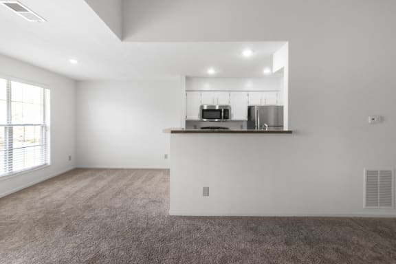 This is a photo of the dining room and kitchen of the 1100 square foot 2 bedroom, 2 bath Eaton floor plan at Washington Park Apartments in Centerville, OH.