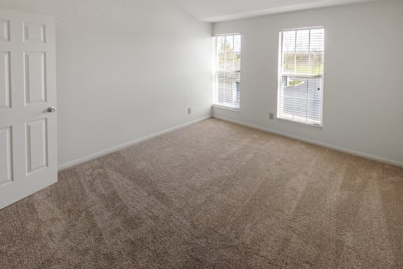 This is a photo of the primary bedroom of the 1100 square foot 2 bedroom, 2 bath Eaton floor plan at Washington Park Apartments in Centerville, OH.