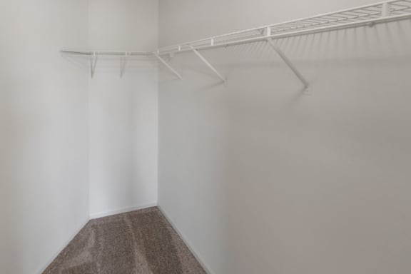 This is a photo of the primary bedroom walk-in closet of the 1100 square foot 2 bedroom, 2 bath Eaton floor plan at Washington Park Apartments in Centerville, OH.