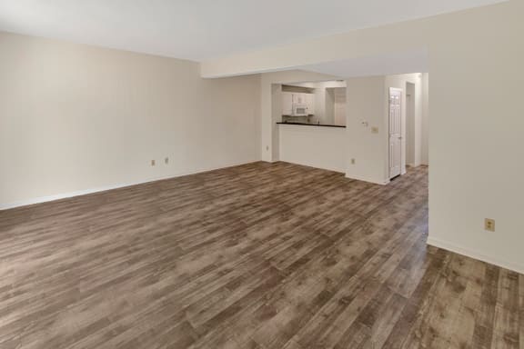 This is a photo of the living room and dining area of the 1280 square foot 2 bedroom, 2 and 1/2 bath Oakwood floor plan at Washington Park Apartments in Centerville, OH.