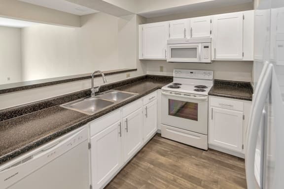 This is a photo of the kitchen of the 1280 square foot 2 bedroom, 2 and 1/2 bath Oakwood floor plan at Washington Park Apartments in Centerville, OH.