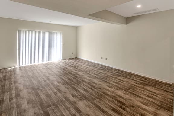 This is a photo of the dining area and living room of the 1280 square foot 2 bedroom, 2 and 1/2 bath Oakwood floor plan at Washington Park Apartments in Centerville, OH.
