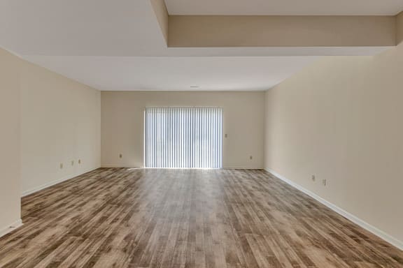 This is a photo of the dining area and living room of the 1280 square foot 2 bedroom, 2 and 1/2 bath Oakwood floor plan at Washington Park Apartments in Centerville, OH.