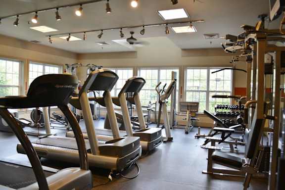 A gym with treadmills and elliptical machines.at Riverview Landing @ Valley Forge, Eagleville Pennsylvania