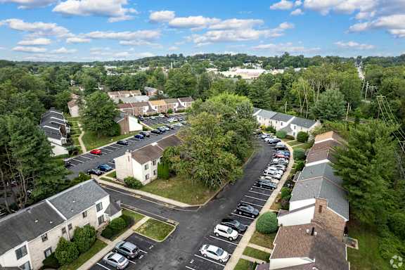 A bird's eye view of a parking lot with cars and a road at Brookshire Trace Townhomes Apartments, Philadelphia, 19116