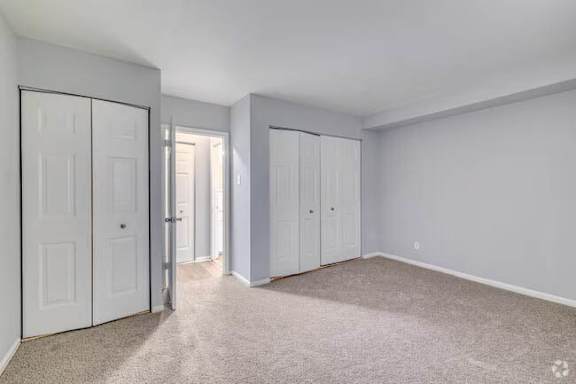A room with white doors and carpeted floor at Brookshire Trace Townhomes Apartments, Philadelphia, 19116