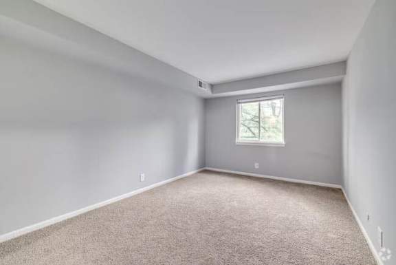 A room with a window and carpeted floor at Brookshire Trace Townhomes Apartments, Philadelphia, 19116